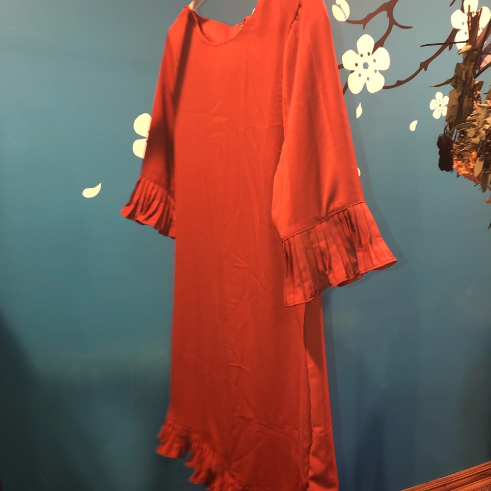 New. Never worn  rust colored. Size small